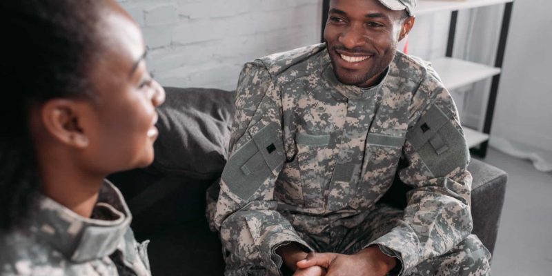 Two soldiers talking, smiling